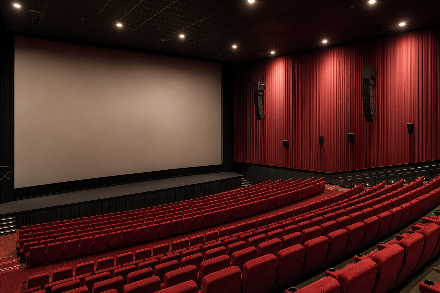 Commercial cinema auditorium with line array speakers and acoustic treatment