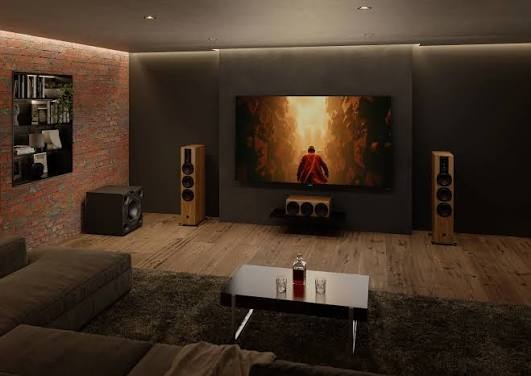 Premium subwoofer system in a luxury listening room with floor-standing speakers and reference display